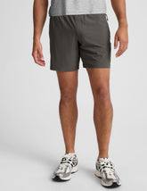 man wearing a gray t-shirt and graphite shorts on a white background.